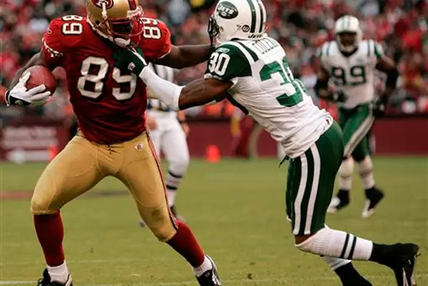 49ers wide receiver Jason Hill, left, stiff-arms New York Jets cornerback Drew Coleman